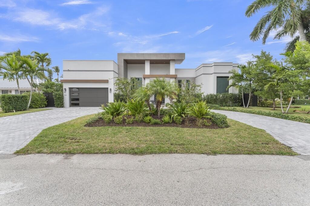 923 Eve Street Delray Beach, FL 33483 - Photo 59 of 69 a front view of a house with a garden