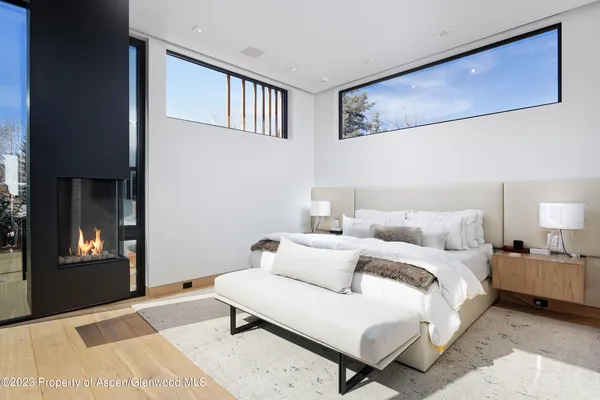 a bedroom with a large bed and a balcony view