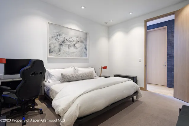 a bedroom with a bed and a night stand