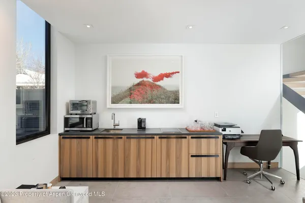 a bedroom with a large bed and a flat tv screen next to a window