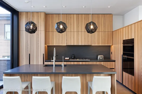 an open kitchen with a table and chairs