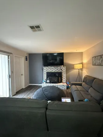 a living room with furniture and a fireplace