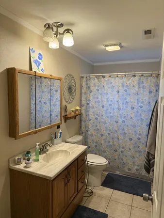 a bathroom with a sink toilet and a mirror