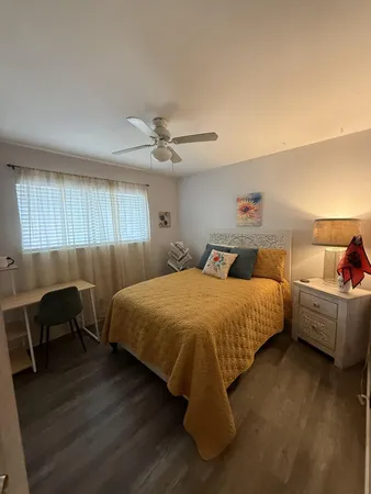 a bed room with a bed and a chair