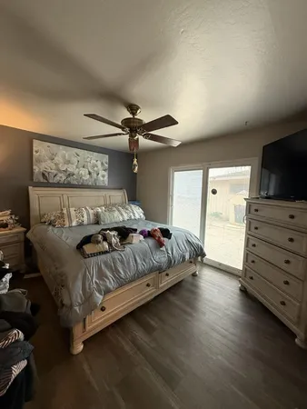 a bedroom with a bed and a flat screen tv