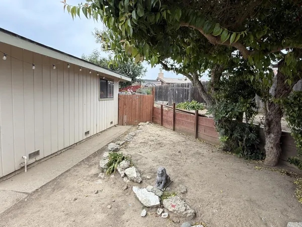 a backyard of a house with mountain view and wooden fence