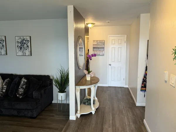 a living room with furniture and wooden floor