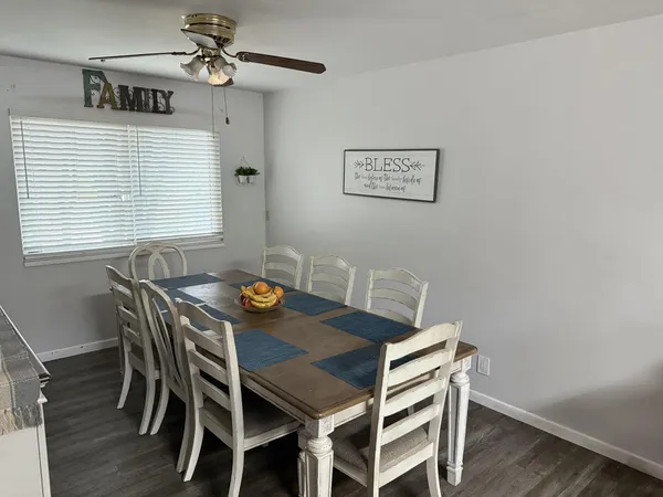 a view of a dining room with furniture and wooden floor