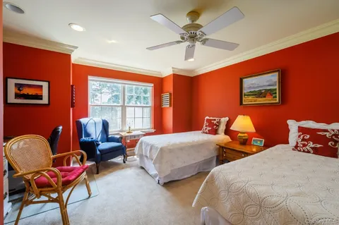 a bedroom with two beds and a chair