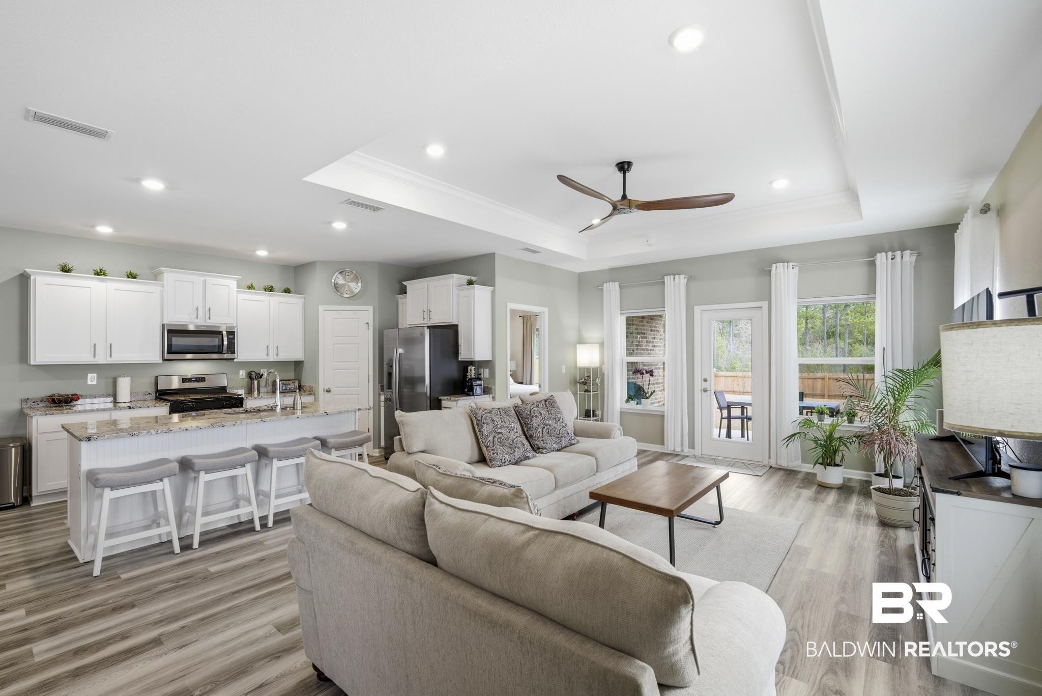 13887 Antler Hl Road Daphne, AL 36527 - Photo 8 of 50 Living room featuring a ceiling fan, light wood-type flooring, recessed lighting, ornamental molding, and a raised ceiling