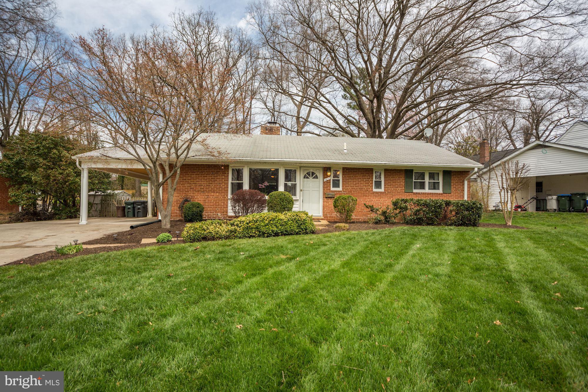 7414 Axton Street Springfield, VA 22151 - Photo 1 of 30 a front view of a house with a yard and trees