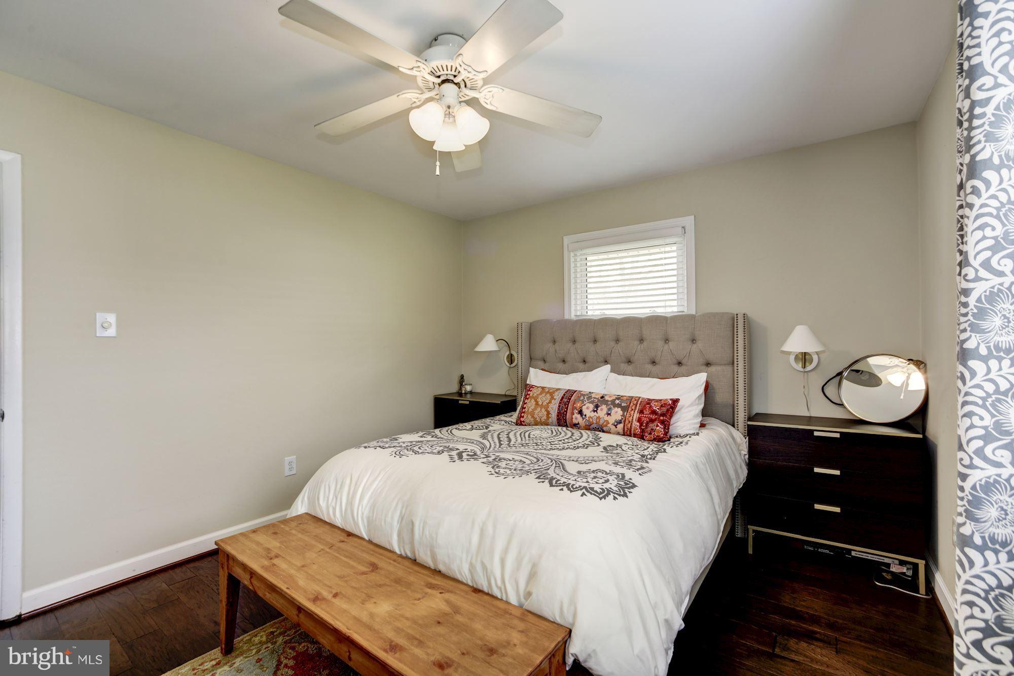 7414 Axton Street Springfield, VA 22151 - Photo 16 of 30 a bedroom with a bed and a chandelier