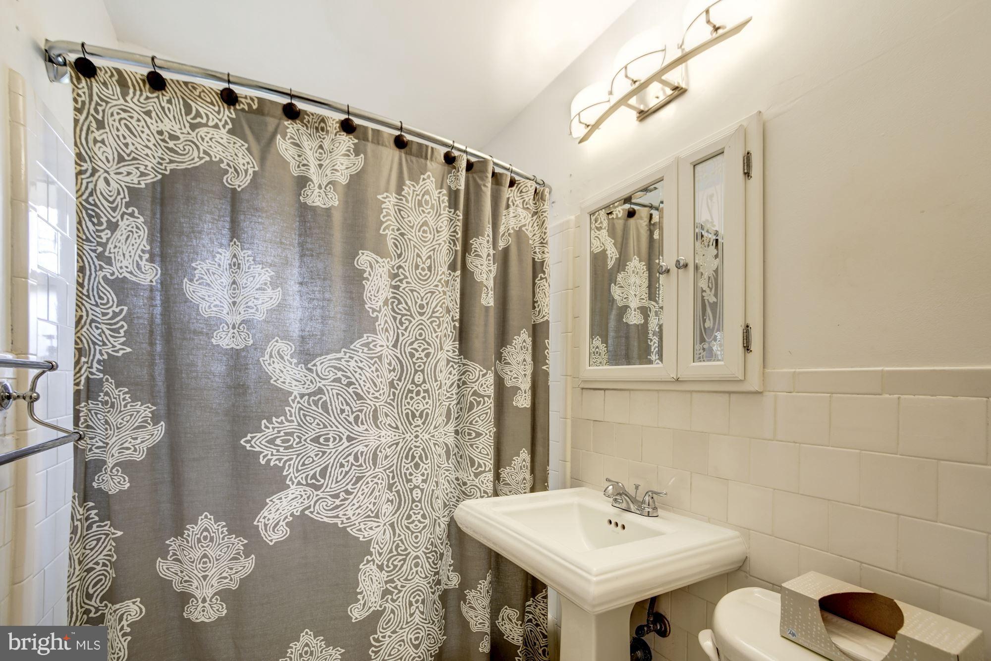 7414 Axton Street Springfield, VA 22151 - Photo 17 of 30 a bathroom with a sink toilet and shower