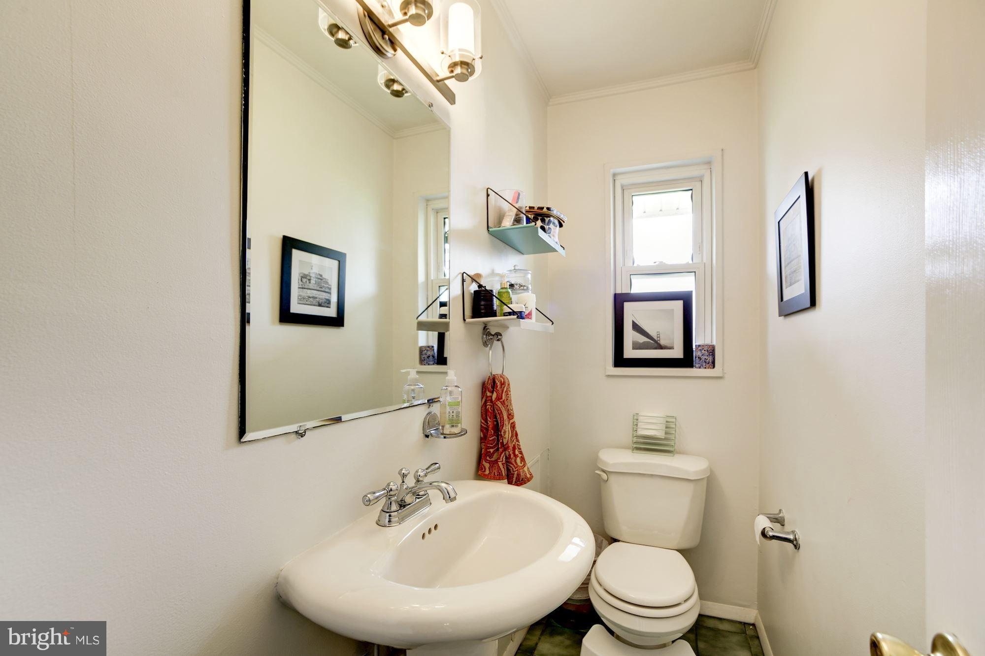7414 Axton Street Springfield, VA 22151 - Photo 22 of 30 a bathroom with a toilet sink and mirror