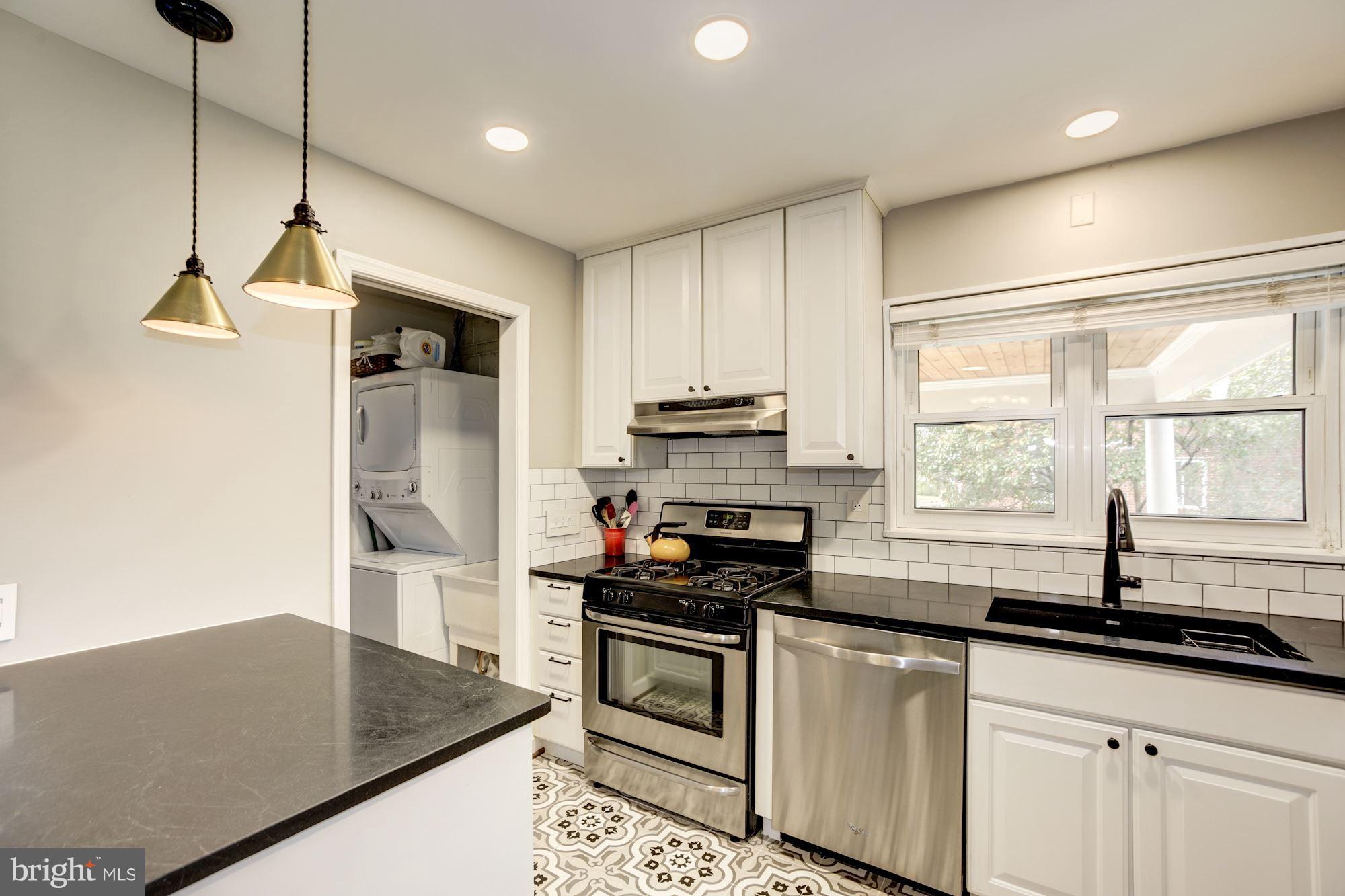 7414 Axton Street Springfield, VA 22151 - Photo 10 of 30 a kitchen with stainless steel appliances granite countertop a sink a stove and a refrigerator
