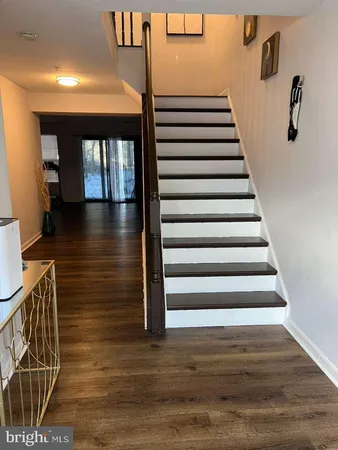 a view of entryway and hall with wooden floor