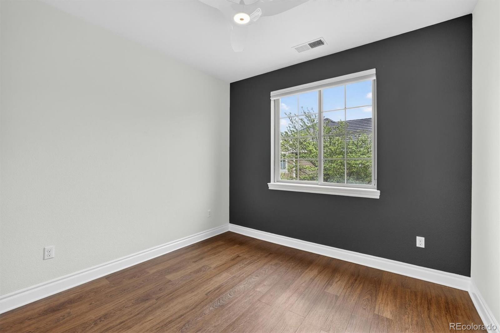 10126 RidgeGate Circle Lone Tree, CO 80124 - Photo 25 of 32 an empty room with wooden floor and windows