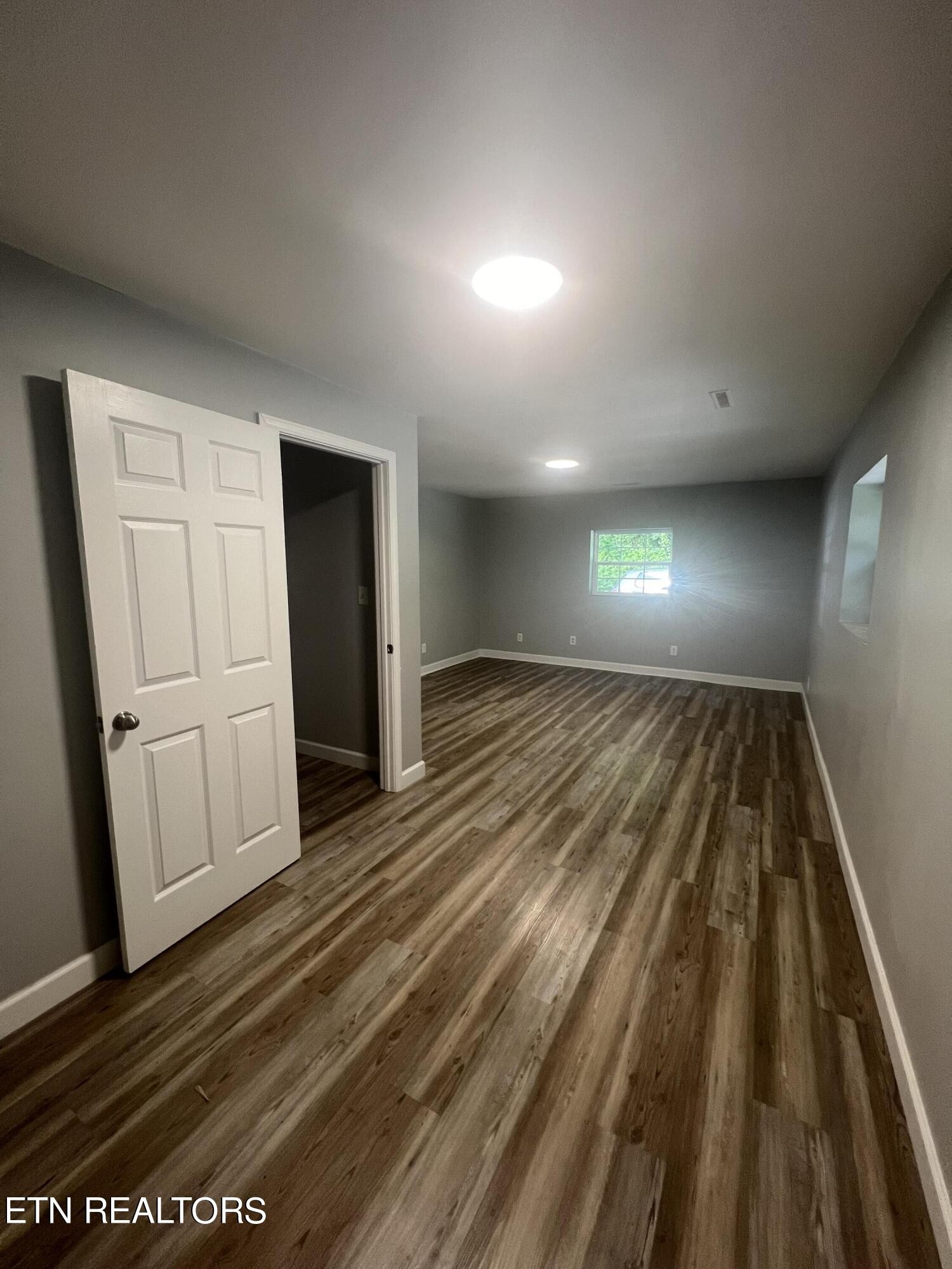 5710 Hyatt Road Knoxville, TN 37918 - Photo 6 of 19 a view of a room with wooden floor stairs and a bathroom