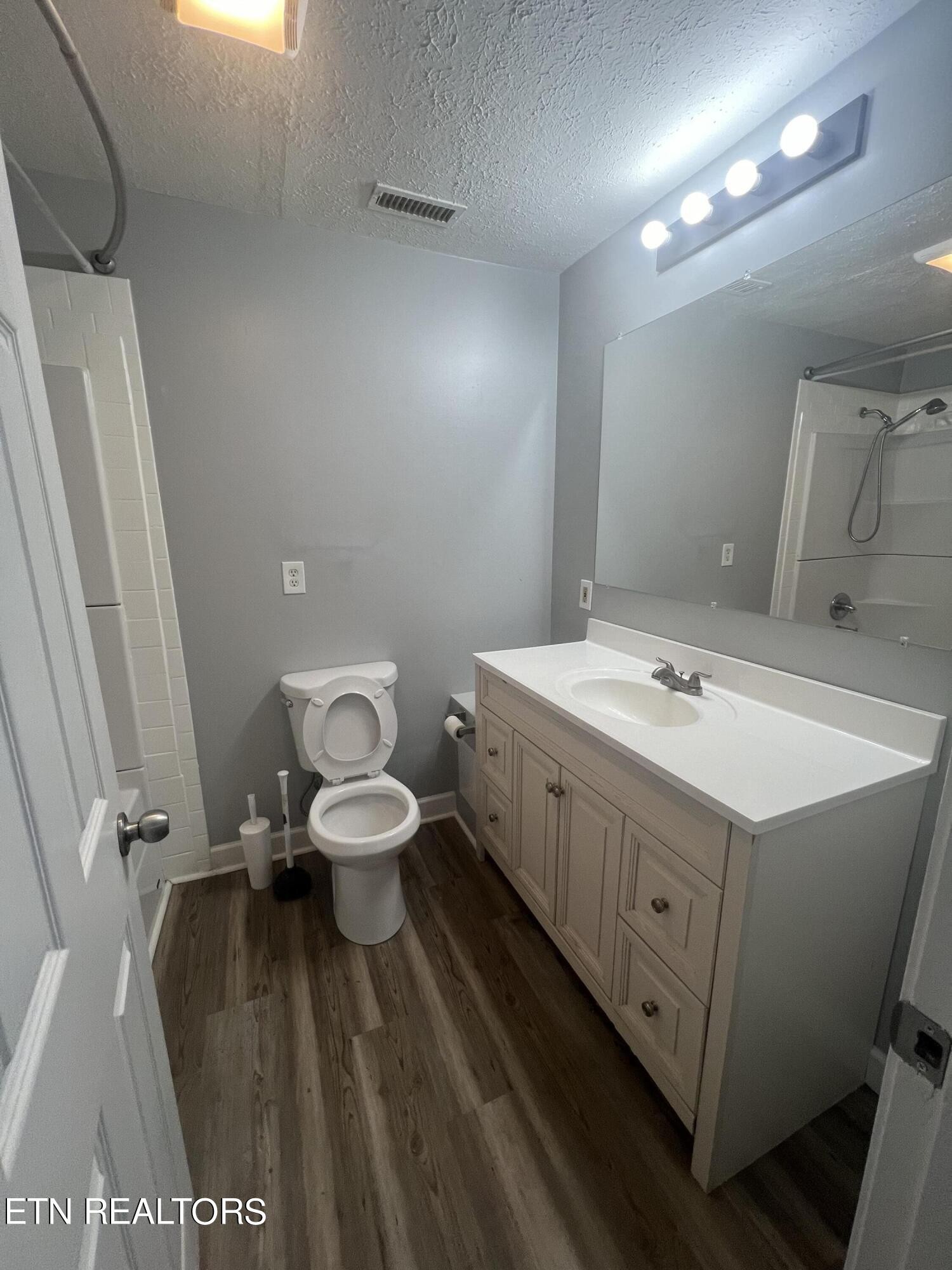 5710 Hyatt Road Knoxville, TN 37918 - Photo 7 of 19 a bathroom with a sink mirror and toilet