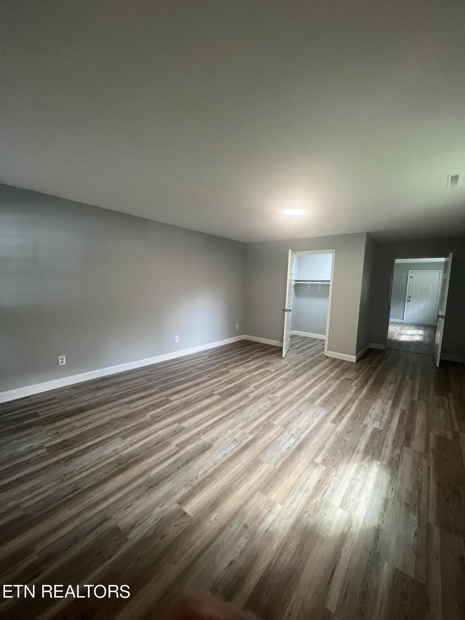 5710 Hyatt Road Knoxville, TN 37918 - Photo 10 of 19 an empty room with wooden floor and windows