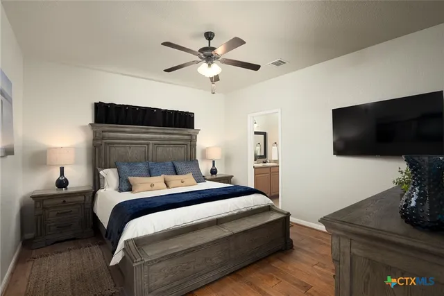 a bedroom with a bed and a flat screen tv