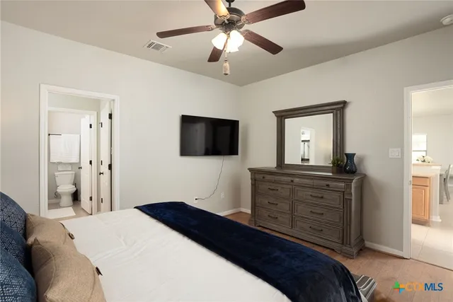 a bedroom with a bed and a flat screen tv