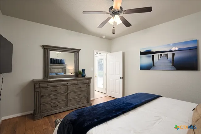 a bedroom with a bed and a mirror on dresser