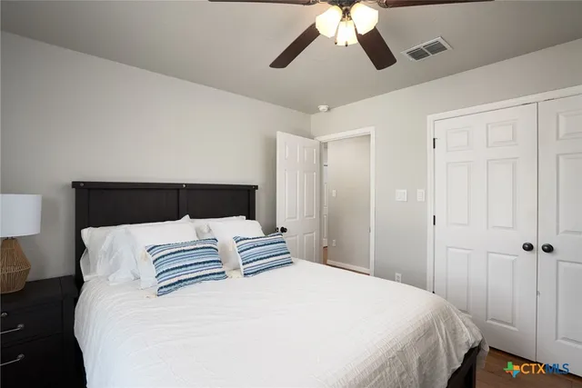 a bedroom with a bed and a chandelier