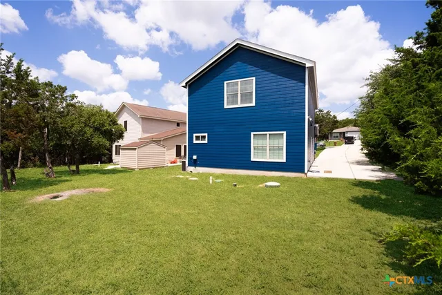 a view of a house with a backyard