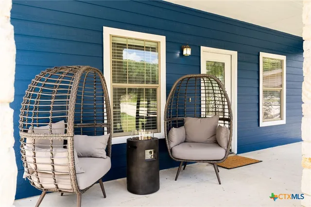 a balcony with furniture and a potted plant