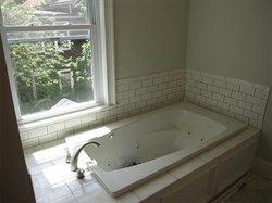 55 Middle Street, Unit 2 Boston, MA 02127 - Photo 2 of 5 a bath tub sitting next to a window
