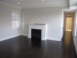 55 Middle Street, Unit 2 Boston, MA 02127 - Photo 4 of 5 a view of an empty room with wooden floor and a window