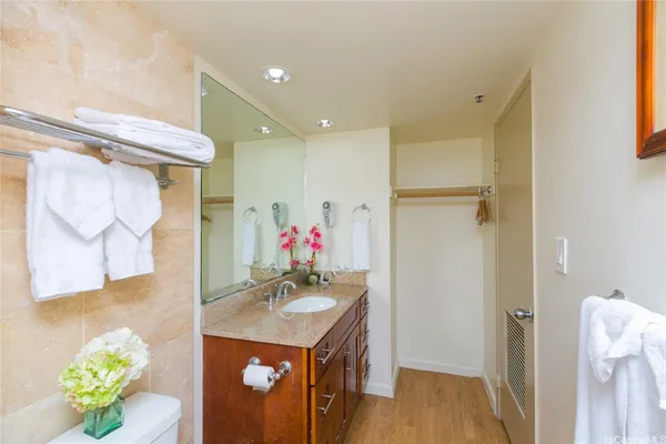 a bathroom with a sink vanity and a mirror