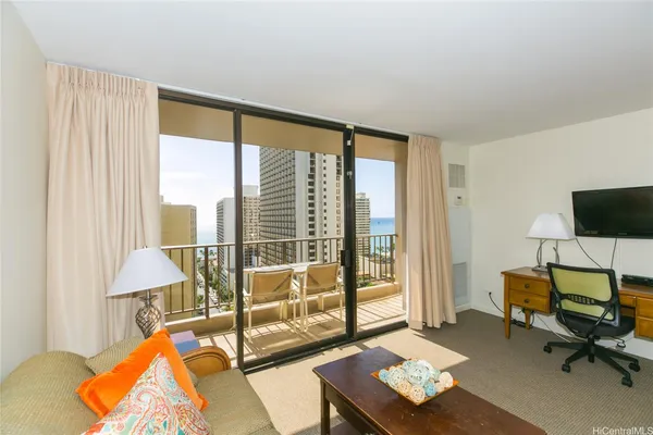 a living room with furniture and a floor to ceiling window