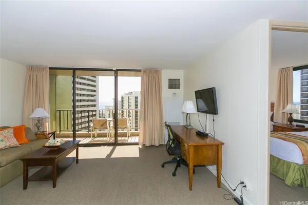 a bedroom with furniture and a flat screen tv