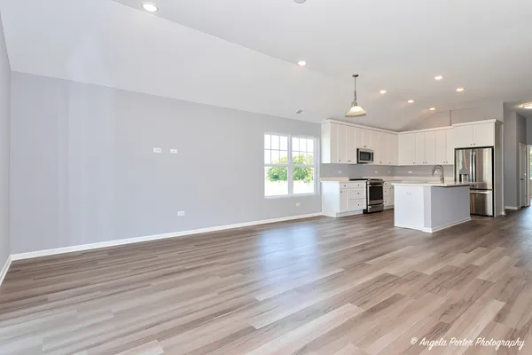 a view of kitchen with wooden floor and window
