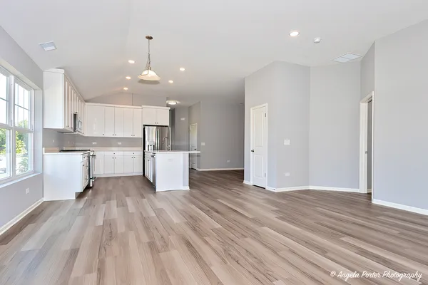 a view of kitchen with wooden floor and window