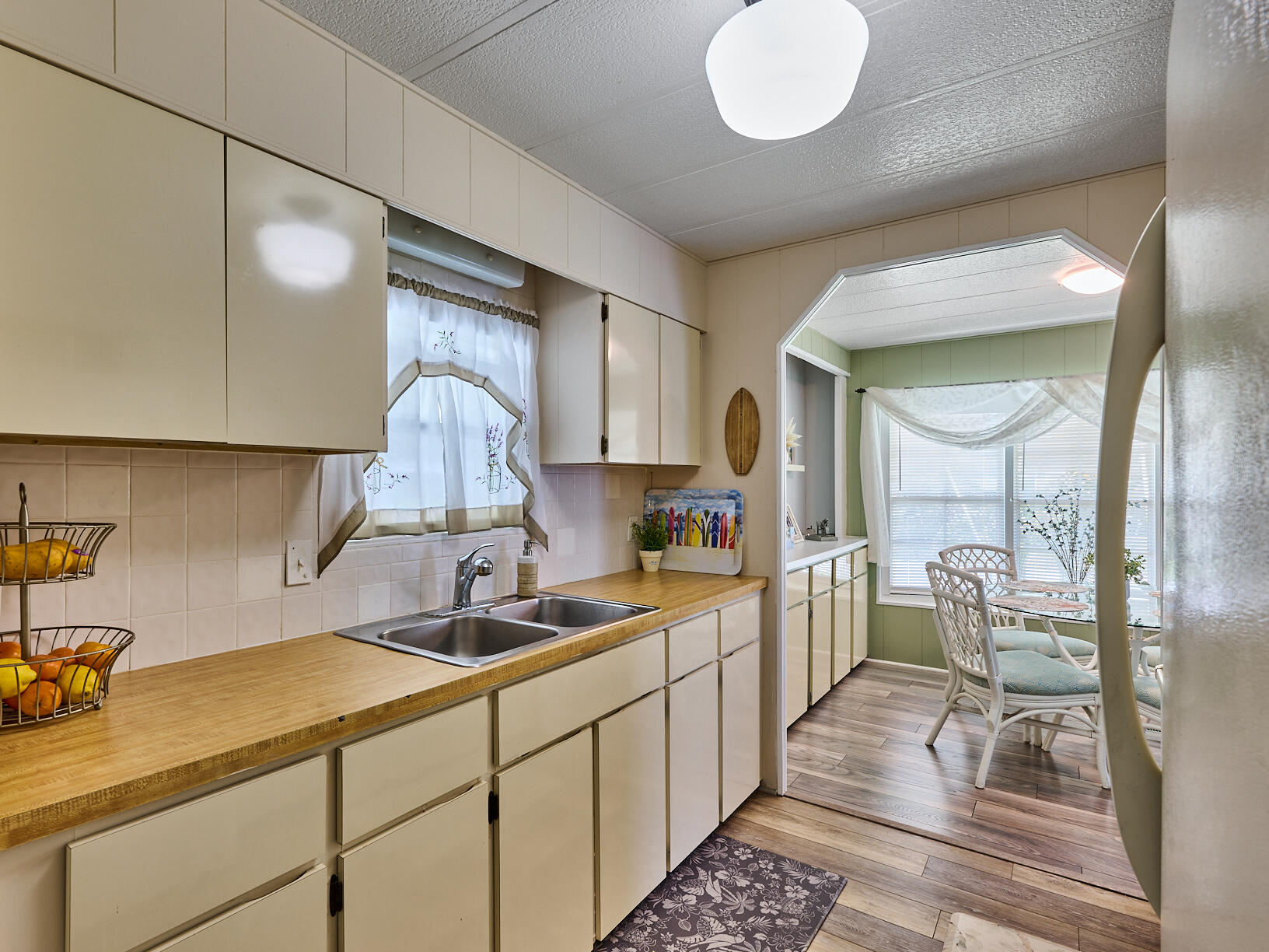 6977 Southeast Delegate Street Hobe Sound, FL 33455 - Photo 14 of 60 a kitchen with a sink and cabinets