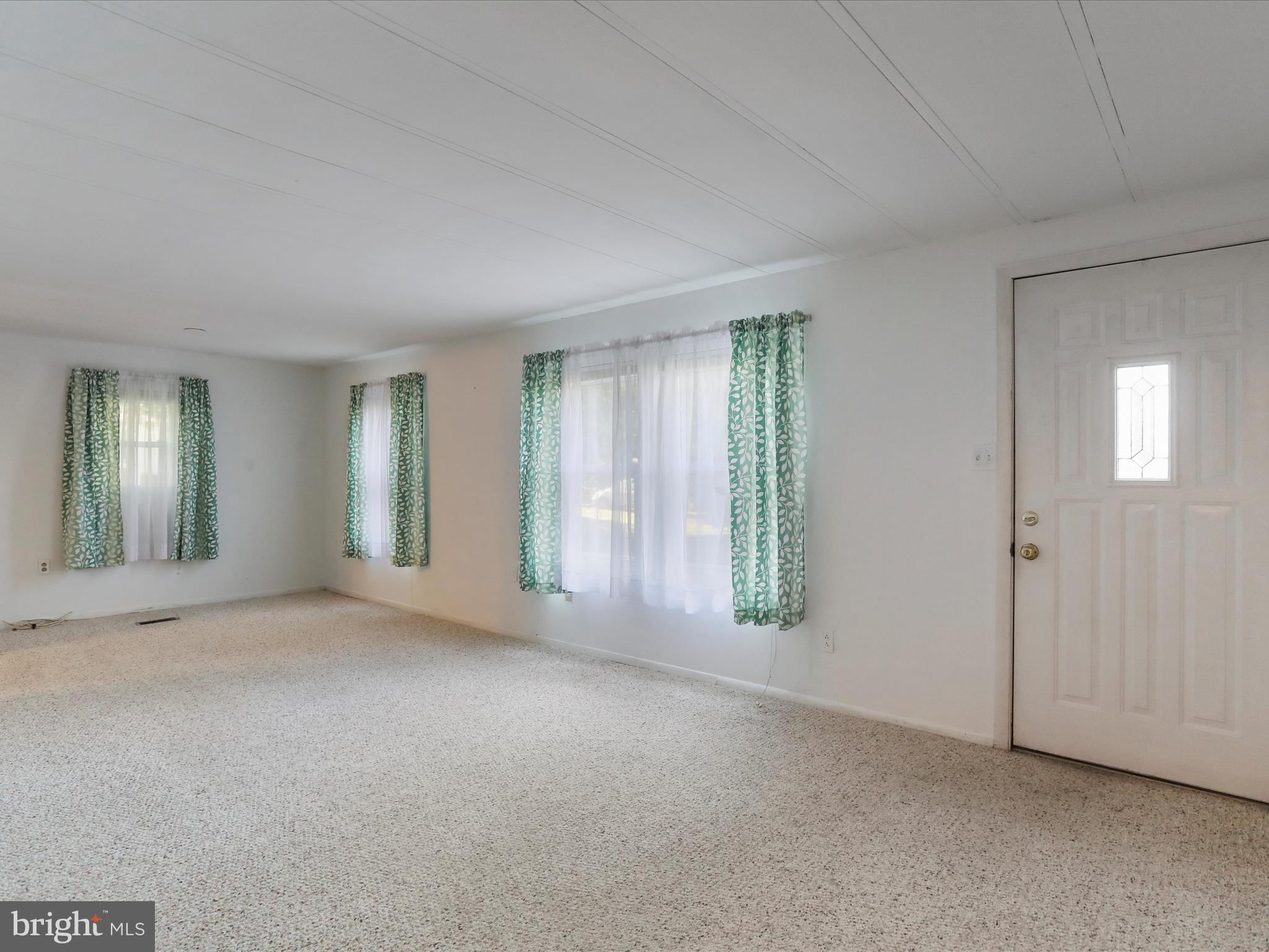 18540 Brooke Road Sandy Spring, MD 20860 - Photo 6 of 39 an empty room with windows and closet area