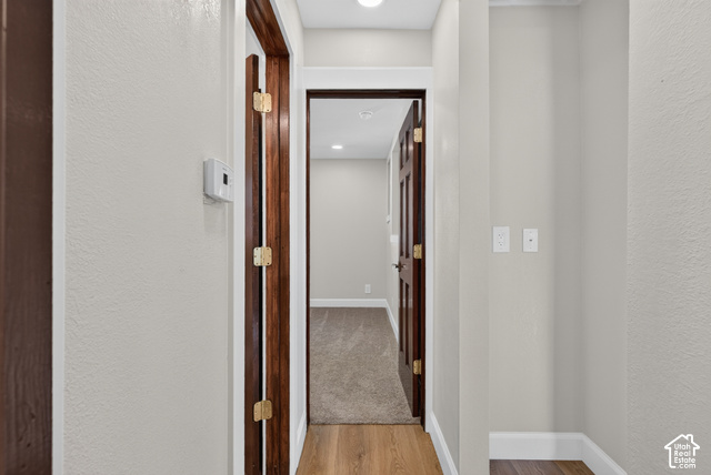 147 Center Street Clearfield, UT 84015 - Photo 21 of 55 Hallway featuring wood-finish flooring, light neutral wall paint, white trim, and recessed lighting