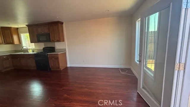 a kitchen with granite countertop a sink and a stove top oven