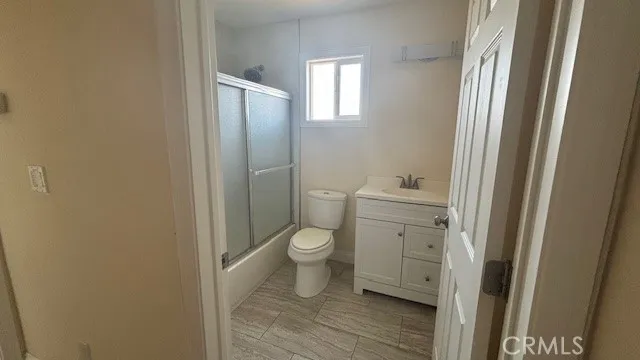 a bathroom with a granite countertop toilet and a sink