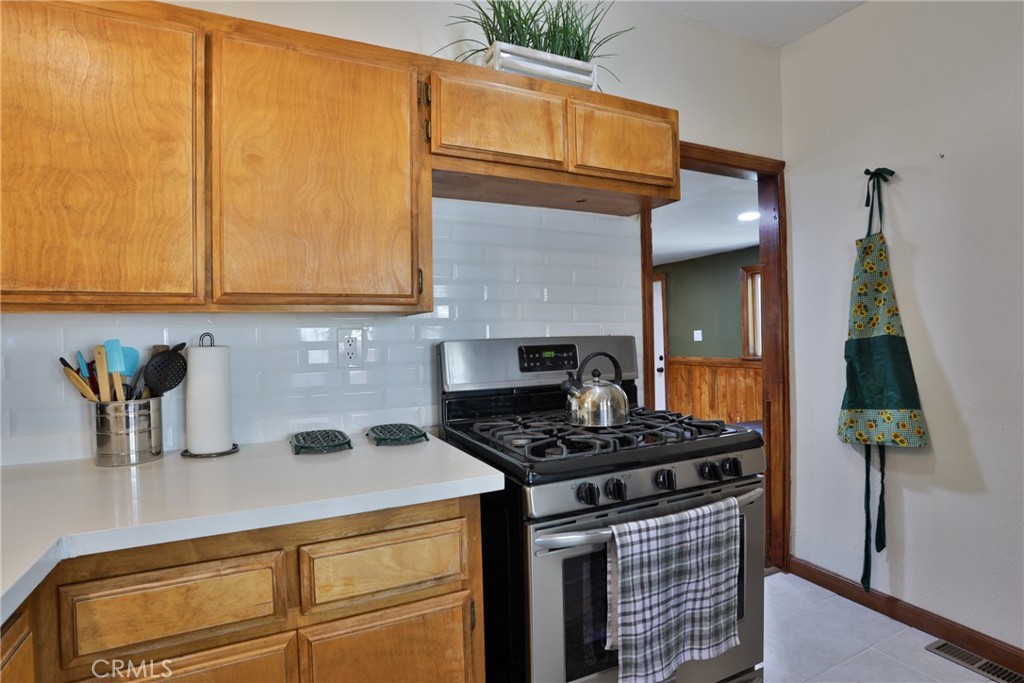 2548 Secret Drive Running Springs, CA 92382 - Photo 11 of 24 a kitchen with stainless steel appliances granite countertop a stove a sink and a microwave