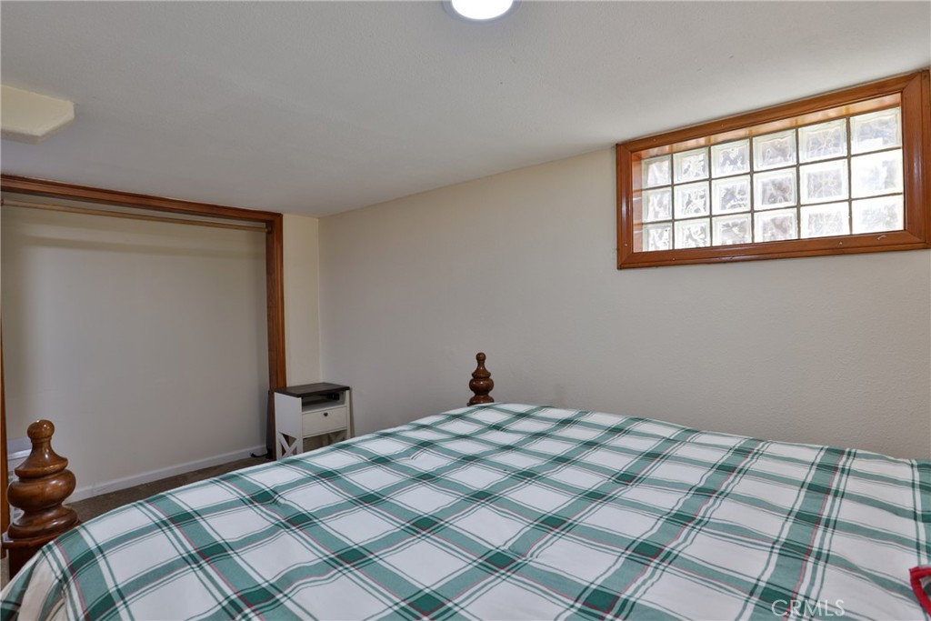 2548 Secret Drive Running Springs, CA 92382 - Photo 17 of 24 a bedroom with a bed and a window