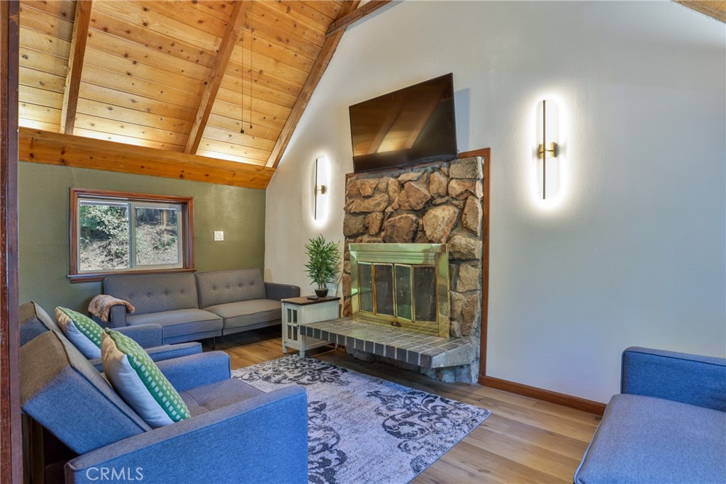 2548 Secret Drive Running Springs, CA 92382 - Photo 2 of 24 a living room with furniture and a flat screen tv