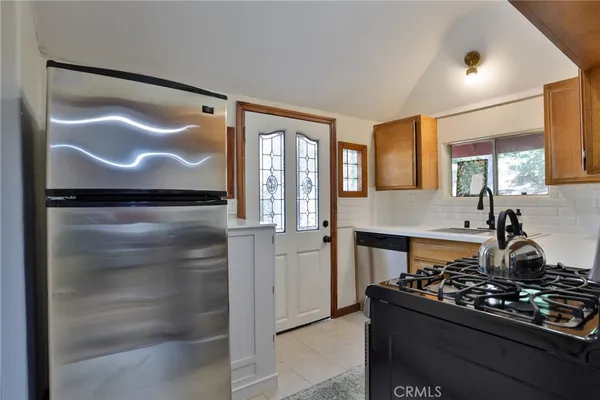 a kitchen with a stove and a refrigerator