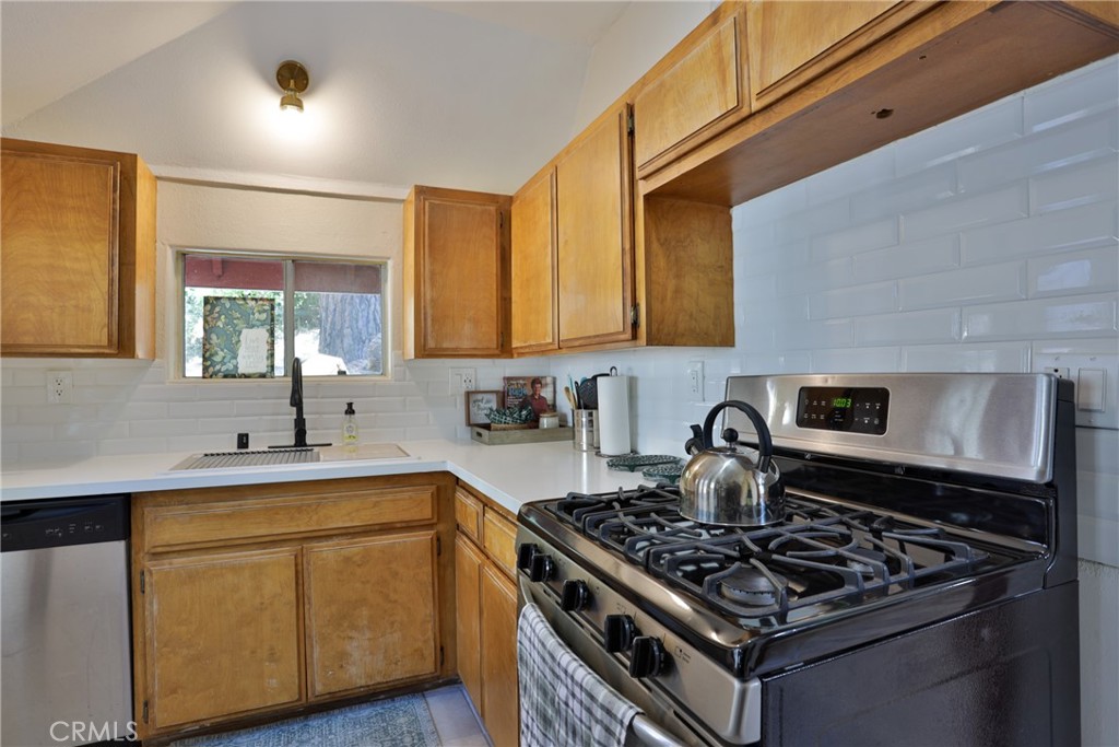 2548 Secret Drive Running Springs, CA 92382 - Photo 10 of 24 a kitchen with a stove and a sink