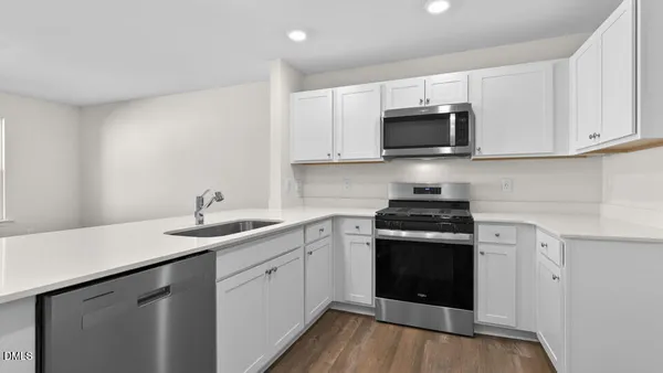 a kitchen with stainless steel appliances granite countertop a sink and stove top oven