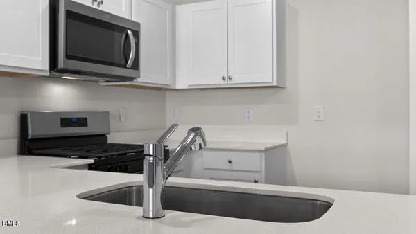 a kitchen with a sink and cabinets