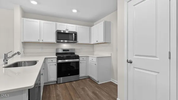 a kitchen with a sink and a stove top oven
